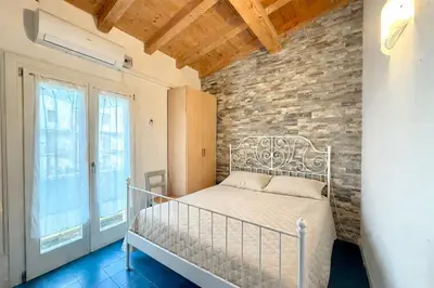 Letto o letti in una camera di Villaggio dei Gabbiani - Carraro Immobiliare - Family Apartments