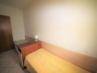 Letto o letti in una camera di Family stay in Rosolina for six guests