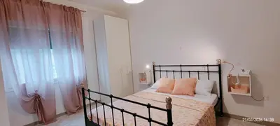 Letto o letti in una camera di APPARTAMENTO ROSA OVER THE RAINBOW APARTMENTS Lido di Jesolo