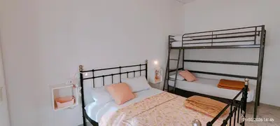 Letto o letti in una camera di APPARTAMENTO ROSA OVER THE RAINBOW APARTMENTS Lido di Jesolo