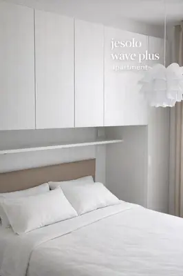 Letto o letti in una camera di Jesolo Lido Apartment with Pool Balcony & Beach Nearby
