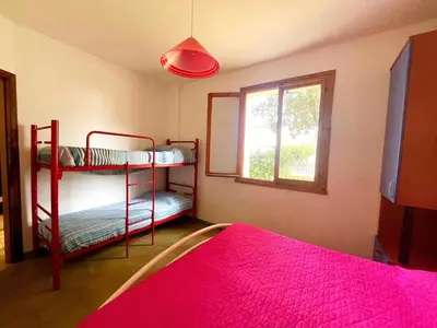 Letto o letti in una camera di Via delle Campanule Apartment for 5