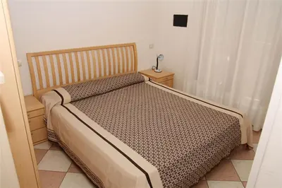 Letto o letti in una camera di Family Apartments Residence Trieste