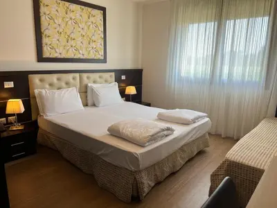 Letto o letti in una camera di GREEN GARDEN Resort - Smart Hotel