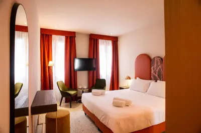Letto o letti in una camera di Palazzina Fortuny