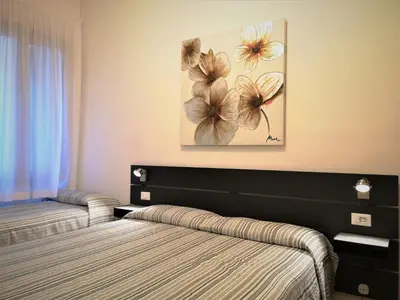 Letto o letti in una camera di Hotel Rossi