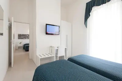 Letto o letti in una camera di Hotel Marina