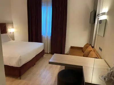 Letto o letti in una camera di Hotel Omnia