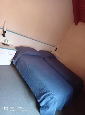Letto o letti in una camera di Locanda Alla Stazione