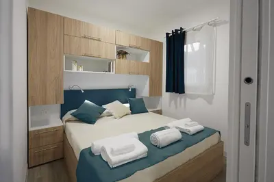Letto o letti in una camera di Village Camping Joker