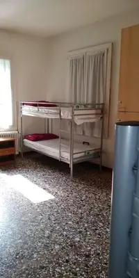 Letto o letti in una camera di Ostello Bassano Del Grappa