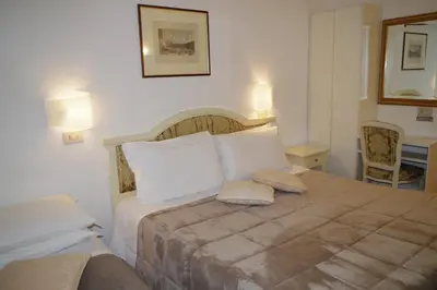 Letto o letti in una camera di Hotel Casa Petrarca