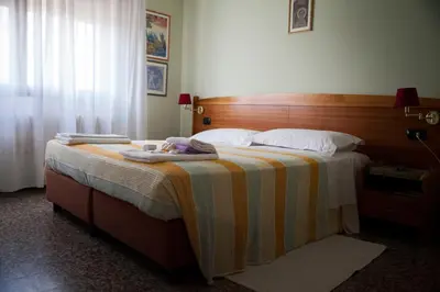 Letto o letti in una camera di Hotel Trieste