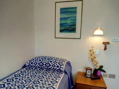 Letto o letti in una camera di Centro Vacanze Opera Nascimbeni