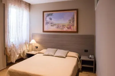 Letto o letti in una camera di Albergo Grappolo D'oro