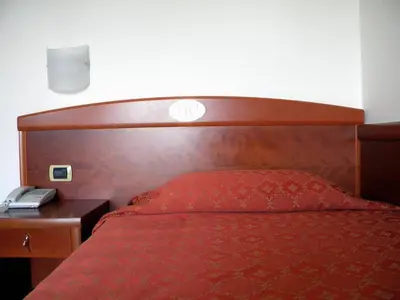 Letto o letti in una camera di Hotel Corone