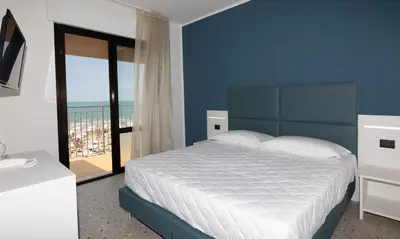 Letto o letti in una camera di Hotel Delaville Frontemare