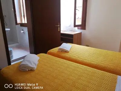 Letto o letti in una camera di Alloggi Gerotto Calderan 1