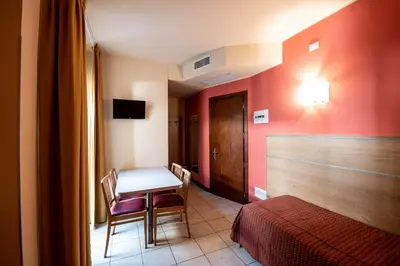 Letto o letti in una camera di Hotel Mondial