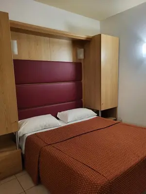 Letto o letti in una camera di Hotel Mondial