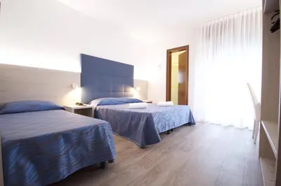 Letto o letti in una camera di Hotel Serenella