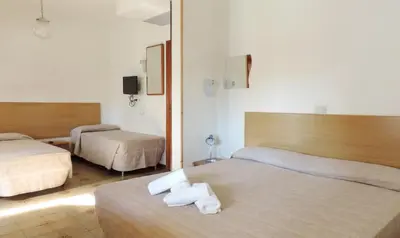Letto o letti in una camera di Hotel Saturno