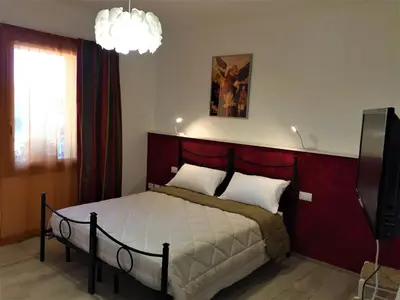 Letto o letti in una camera di B&B L'arte è di casa