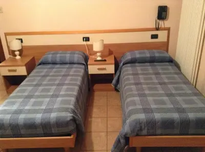 Letto o letti in una camera di Hotel Amba Alagi