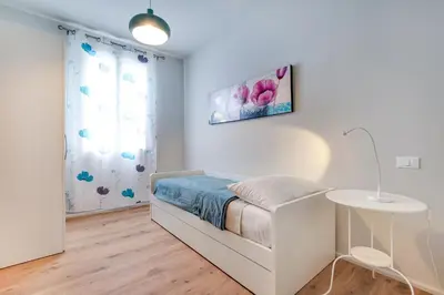 Letto o letti in una camera di Lido's Garden Apartment