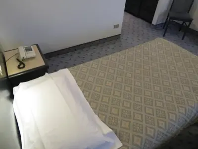 Letto o letti in una camera di Hotel Turandot-Osteria-Pizzeria 