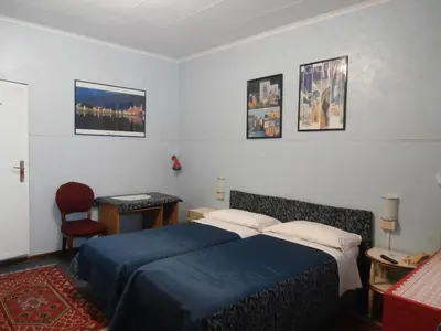 Letto o letti in una camera di Albergo Junior