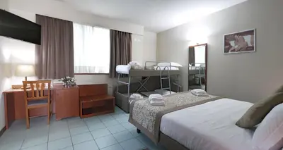Letto o letti in una camera di ALA Hotel