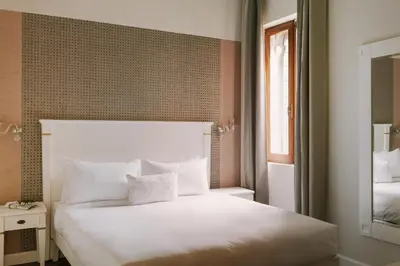 Letto o letti in una camera di iH Hotels Venezia Salute Palace