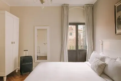 Letto o letti in una camera di iH Hotels Venezia Salute Palace