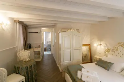 Letto o letti in una camera di Ca' Vittoria Boutique House ApartSuite Chioggia