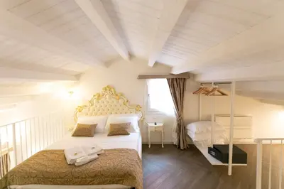 Letto o letti in una camera di Ca' Vittoria Boutique House ApartSuite Chioggia