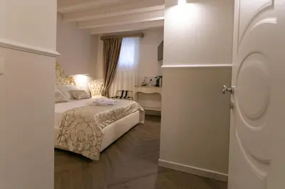 Letto o letti in una camera di Ca' Vittoria Boutique House ApartSuite Chioggia