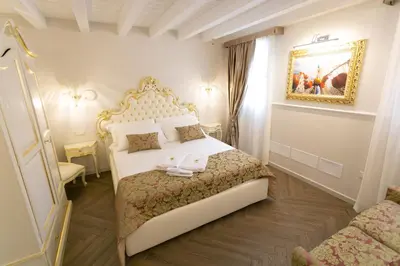 Letto o letti in una camera di Ca' Vittoria Boutique House ApartSuite Chioggia