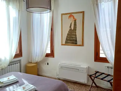 Letto o letti in una camera di Fortuny Loft