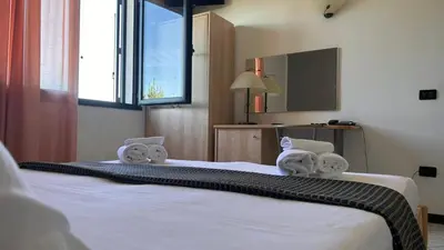 Letto o letti in una camera di Hotel Gran Delta di ALBA-INVEST srl