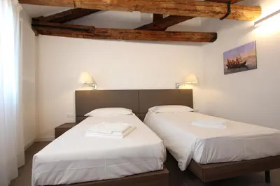 Letto o letti in una camera di Residence degli Artisti