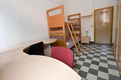 Letto o letti in una camera di Ostello Domus Civica