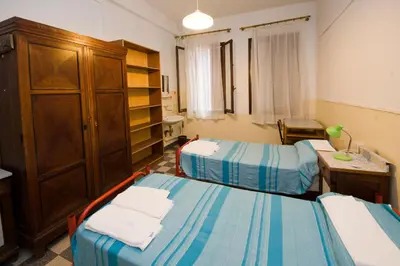 Letto o letti in una camera di Ostello Domus Civica