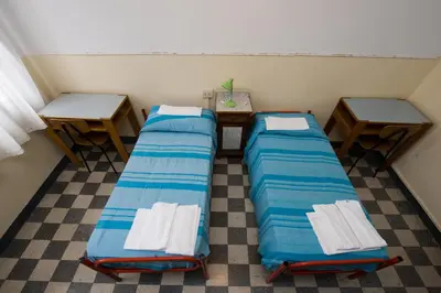 Letto o letti in una camera di Ostello Domus Civica