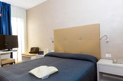 Letto o letti in una camera di Hotel Touring