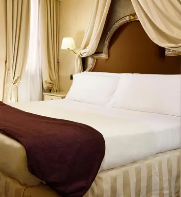 Letto o letti in una camera di Residenza Venezia | UNA Esperienze
