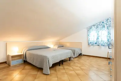 Letto o letti in una camera di Quadrilocale e Mansarde Bafile241 - Adria Holiday Jesolo - FAMILY APARTMENTS