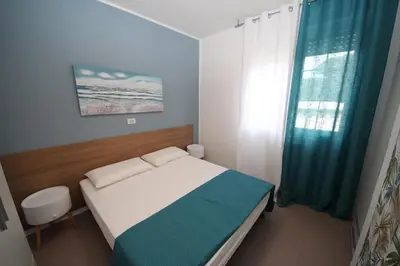 Letto o letti in una camera di Residence Verdena appartamento 02