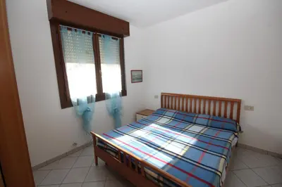 Letto o letti in una camera di Acquasmeralda appartamento 03