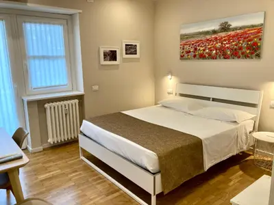 Letto o letti in una camera di Maison Altinia, locazione in centro storico a due passi dalla stazione